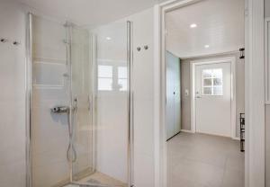 a bathroom with a shower with a glass door at Panoramic View of Voss - Private Cabin & Patio in Vossevangen +19 photos