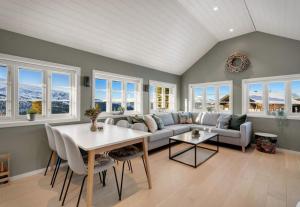 a living room with a couch and a table at Panoramic View of Voss - Private Cabin & Patio in Vossevangen