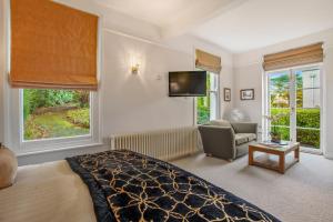 a bedroom with a bed and a tv on the wall at St Elizabeth's House in Plymouth