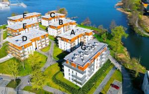 an aerial view of a building on the water at Randez-View - 60 m2, widok na jezioro z tarasu, duży taras, klima, parking, Netflix in Iława