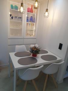 a white table with two chairs and a refrigerator at Green Home Bihać in Bihać +29 photos