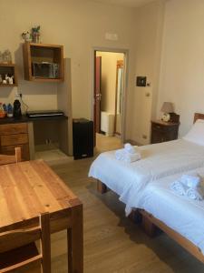 a room with two beds and a table and a kitchen at La Mandulera in Rivalta di Torino