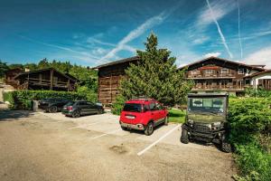 a car parked in a parking lot in front of a house at Les Mazots du Hameau - Charme Alpin avec Cuisine équipée in Vercorin