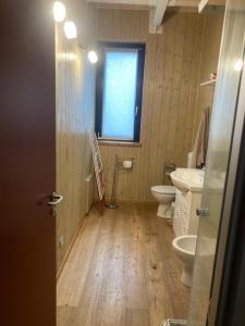 a bathroom with two toilets and a sink and a window at La Mandulera in Rivalta di Torino +9 photos