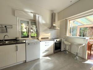 a kitchen with white cabinets and a sink and a window at Casa Los Campones en Asturias VV-3585-AS in Nava +42 photos