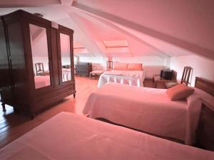 a bedroom with two beds and a dresser in a room at Casa Los Campones en Asturias VV-3585-AS in Nava