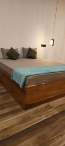 a large bed with a wooden frame in a room at Villa #1 in Unawatuna