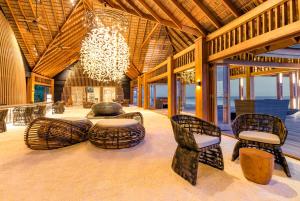 a large room with chairs and a chandelier at Hurawalhi Island Resort in Kuredu