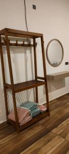 a shelf with a mirror and some towels at Villa #1 in Unawatuna