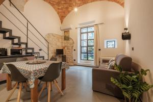 a living room with a table and a couch at Via Roma 106 Apartment in Sassari