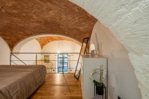 a room with a bed and a refrigerator at Via Roma 106 Apartment in Sassari