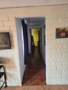 a hallway leading into a room with a brick wall at Margaret in Combarbalá +8 photos