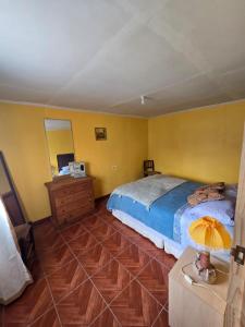 a bedroom with a bed and a dresser and a mirror at Margaret in Combarbalá