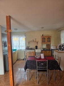 a kitchen with a table and chairs in a room at Margaret in Combarbalá