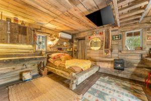 a bedroom with a bed in a wooden cabin at Squatter's Cabin (Off-Grid): Includes 1-UTV in Jasper