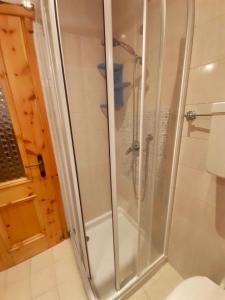 a shower with a glass door in a bathroom at Baita Azzurro in Isolaccia +2 photos