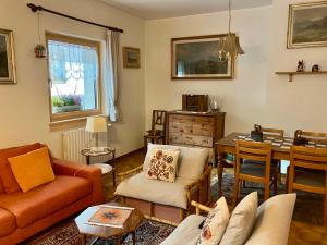 a living room with a couch and a table at Baita Azzurro in Isolaccia