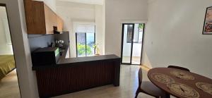 a kitchen with a table and a dining room at New, modern, amazing terrace in Taxco de Alarcón