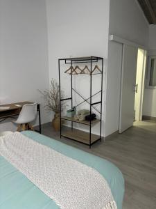 a bedroom with a bed and a table and a desk at Origen Bed and Breakfast in Villargordo del Cabriel