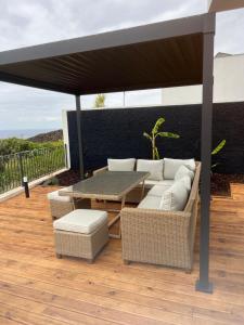 a patio with a couch and a table under a canopy at Villa Atlantic Lodjadis in Gaula
