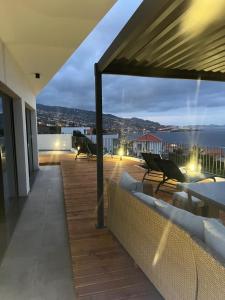 a balcony with couches and a view of the ocean at Villa Atlantic Lodjadis in Gaula +48 photos