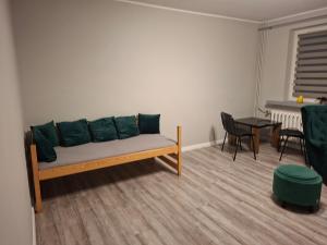 a living room with a couch and a table at Piąteczka in Pniewy
