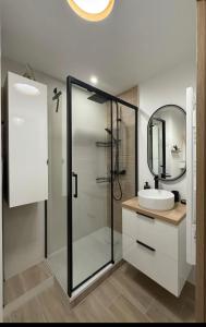a bathroom with a glass shower and a sink at L'Original in Hyères +22 photos