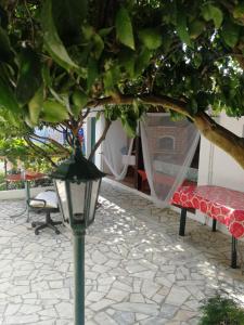 a street light next to a bench and a tree at The Lemon Tree House in Quinta do Conde