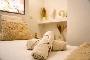 a bedroom with a bed with towels on it at Welcome to Hidden Spa in Wissous