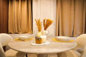 a table with plates and candles on top of it at Welcome to Hidden Spa in Wissous +13 photos