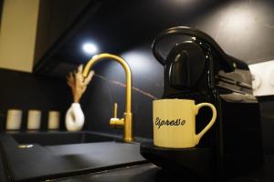 a coffee cup sitting on a counter next to a sink at Welcome to Hidden Spa in Wissous