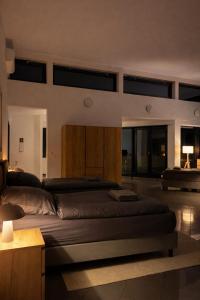 a bedroom with a large bed in a room with windows at Monteur- und Ferienunterkunft Ludwigsfelde in Ludwigsfelde +30 photos