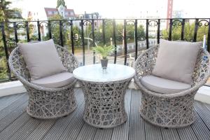 two chairs and a table on a balcony at Stadtperle Rostock in Rostock