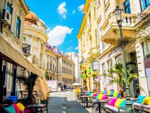 a street with tables and chairs in a city at Old Town Boutique Hotel in Bucharest