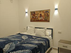 a bedroom with a bed with two lights on the wall at NOOR SEEN House in Luxor +53 photos