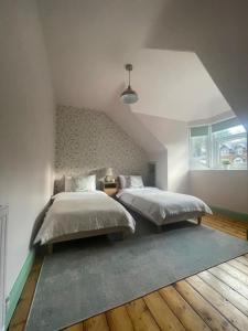 a bedroom with two beds in a attic at Historic Highland Townhouse in Fort William