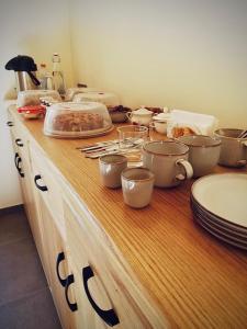 a kitchen counter with pots and pans and dishes on it at Agriturismo Cebon in Ceva