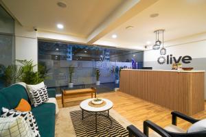 a living room with a couch and a table at Olive Hotel Baner by Embassy Group in Pune