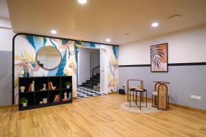 a living room with a painting on the wall at Olive Hotel Baner by Embassy Group in Pune +15 photos