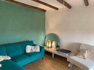 Una sala de estar con un sofá azul y un espejo. en Vale, en Vale
