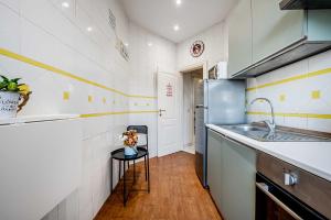 a kitchen with a sink and a refrigerator at Domus Antica Trastevere in Rome +36 photos