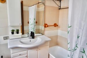 a bathroom with a sink and a shower curtain at Dany's house in Lecco +26 photos