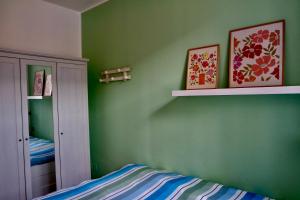 a green bedroom with a bed and a green wall at Dany's house in Lecco