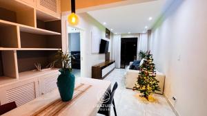 a living room with a christmas tree in a room at Apartamento Centro Ubatuba - Ubatuba House Temporada in Ubatuba