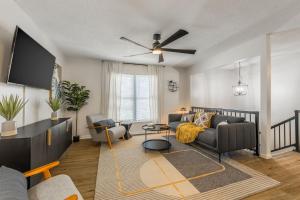 a living room with a couch and a tv at 4BR World Cup Fan HQ SuperHost Close to Stadium in Pleasant Valley