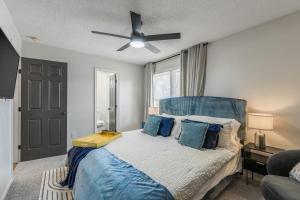 a bedroom with a bed with a ceiling fan at 4BR World Cup Fan HQ SuperHost Close to Stadium in Pleasant Valley