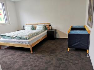 a bedroom with a bed and a dresser in it at Apartment HIRSCHEN by Interhome in Gossau