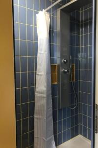 a shower with a white dress hanging on a wall at Apartment sunehus-ch by Interhome in Stein
