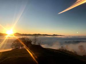 a view of a foggy sunrise with the sun rising over the horizon at Apartment sunehus-ch by Interhome in Stein