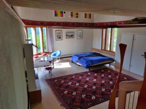 a bedroom with a bed and a desk and a rug at Apartment sunehus-ch by Interhome in Stein +7 photos
